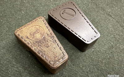 Dark brown protective case for storing shaving razor and spare blades.