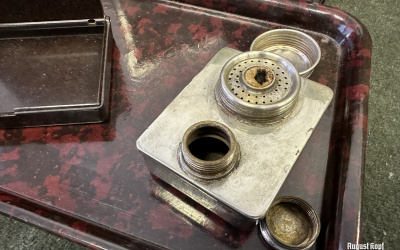 A 1930-1950 era vintage desk set consist of a bakelite tray, bakelite box and a metal table lighter, leather wallet.