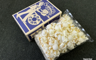 Salted popcorn sealed in a cellophane bag and packed in a reproduction 1930’s-1940’s box.