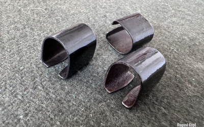 Metal reproduction of rifle sight part.