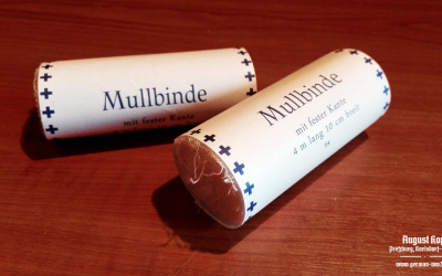 Simple medical bandage, rolled in paper wrapper with printed information: 4m length, 10cm width.