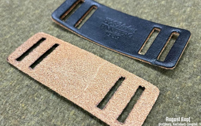 Pair of leather reinforcements for gas mask straps.
